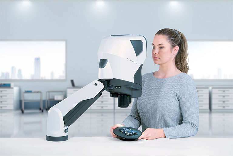 Woman inspecting PCB using tilting base and Mantis PIXO